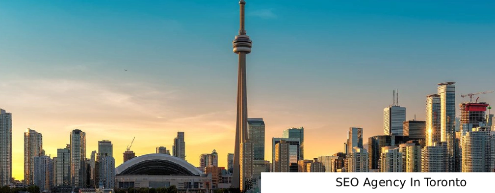 SEO Agency In Toronto sunset view of the Toronto skyline featuring the CN Tower and city skyscrapers under a glowing orange sky.